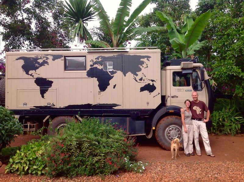 Two overland travelers and their expedition truck