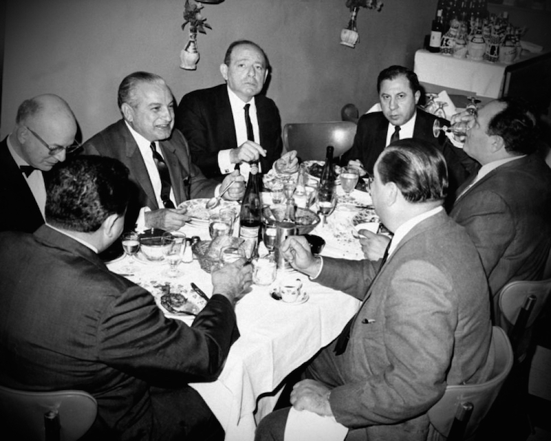 mafia man sitting around dinner table